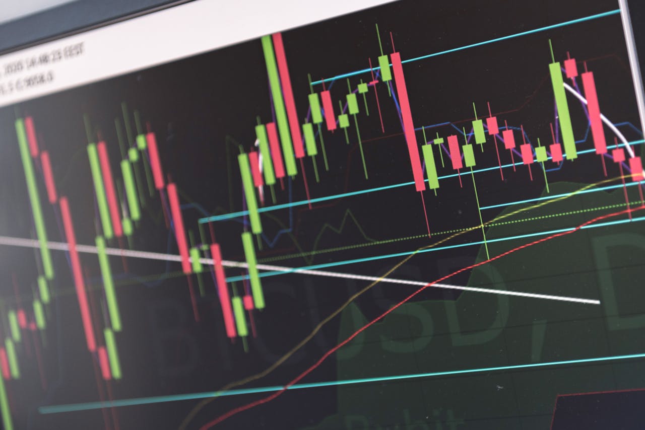 our-experience Close-up of vibrant stock market graphs displaying trading trends on a monitor, ideal for finance and cryptocurrency concepts.